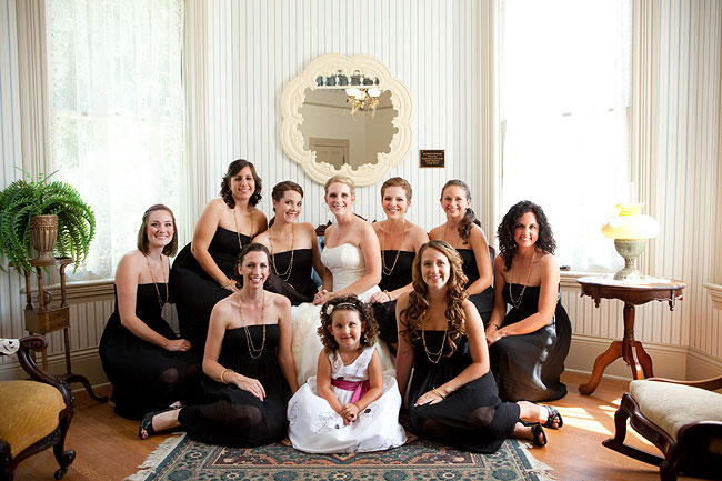 bridesmaids in black dresses sit in room at Camarillo Ranch