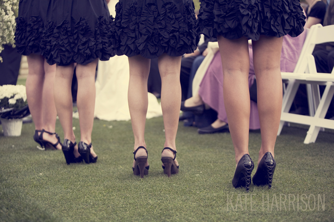 bridesmaid wearing ruffled black dresses and black heels