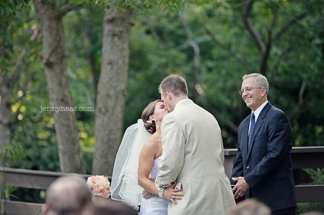 bride and groom kiss at wedding ceremony