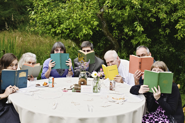 wedding guests holding old books up