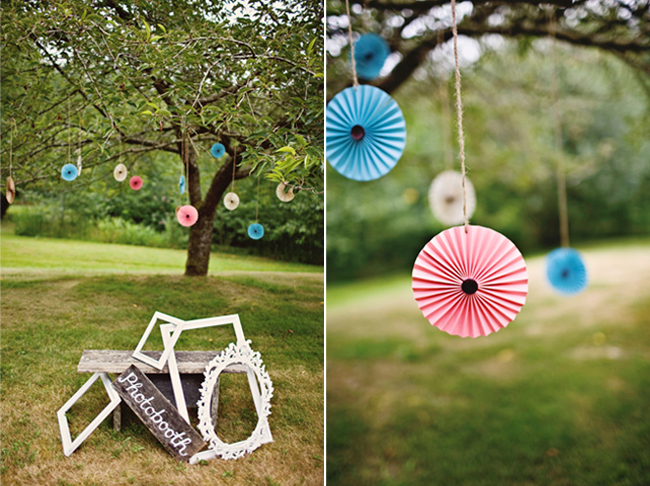 outdoor photobooth with paper pinwheels hanging from tree