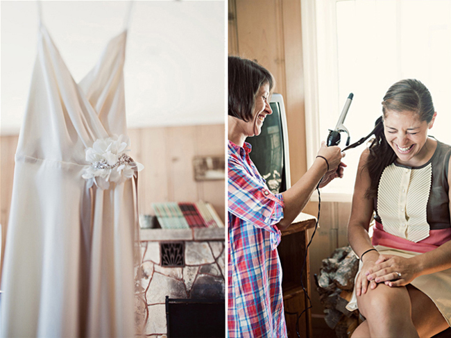 Wedding dress hangs while bride gets her hair curled