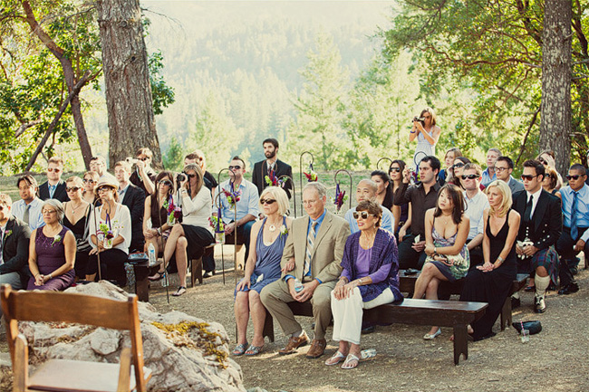 Outdoor wedding ceremony at Anvil Vineyard & Ranch with guests sitting on wooden benches