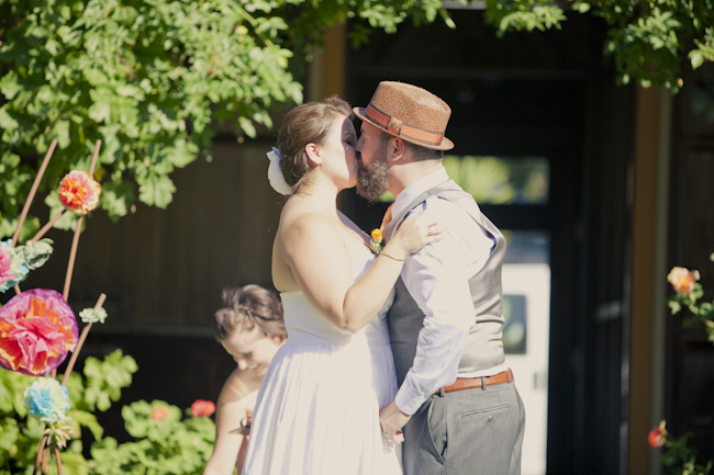bride and groom kiss at ceremony