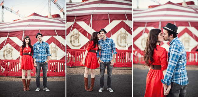 Dressed in a red dress with boots as couple kiss at country fair engagement session