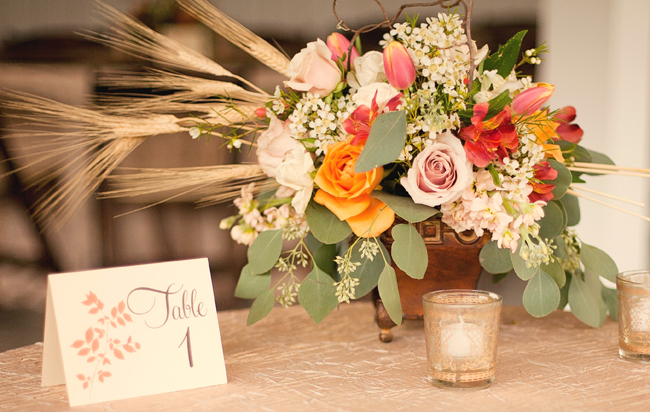 centrepiece flower arrangement, candles, and table number