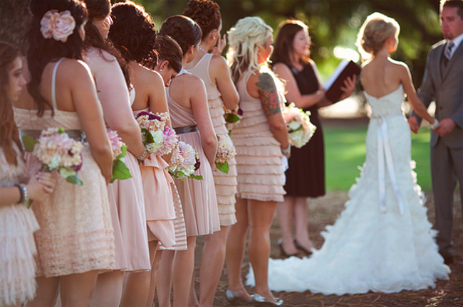 bridesmaids in short pink dresses in a row