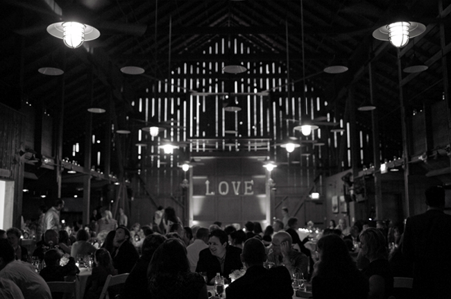 black and white photo of interior barn reception