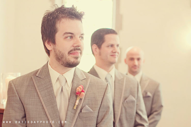 groom in grey suit with groomsmen behind
