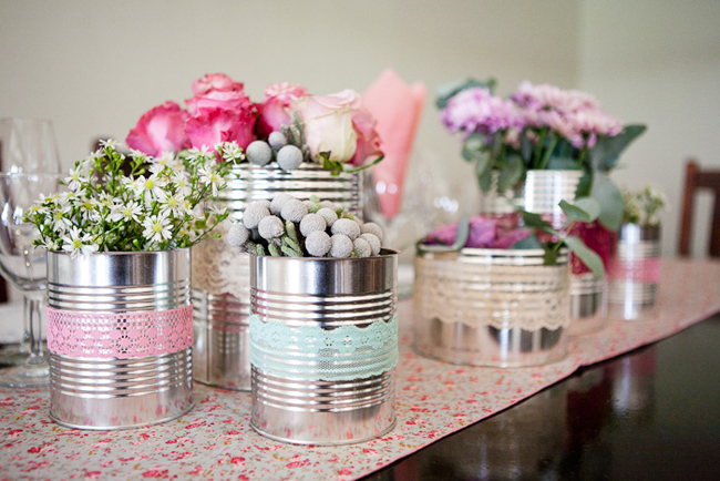 flowers in tin cans on reception table
