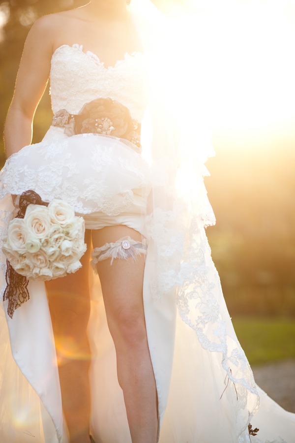 bride displaying her custom-made garter