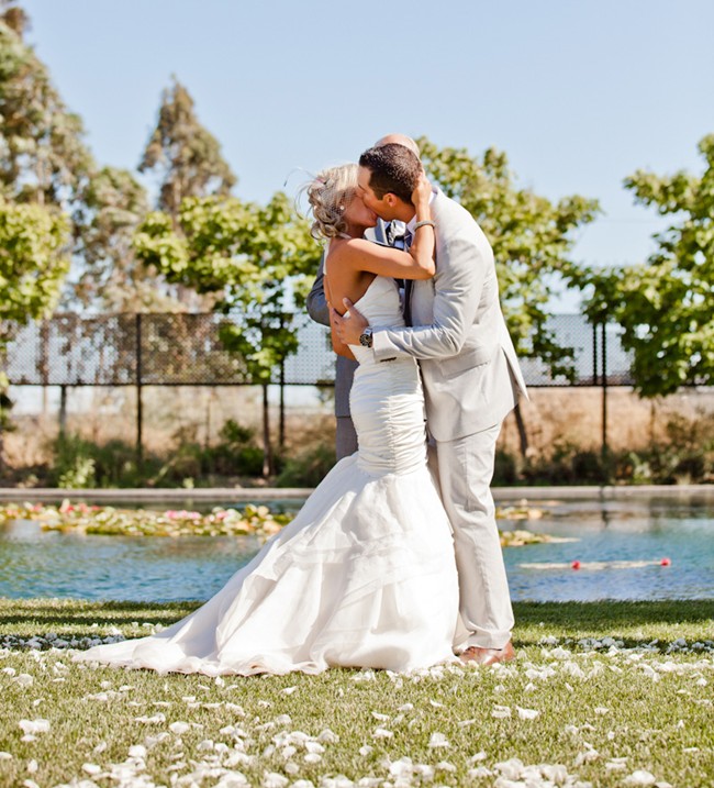 Bride and groom kissing during wedidng ceremony at corner stone gardens