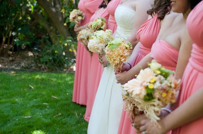 bridesmaids in pink dresses with bouquets