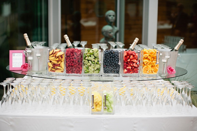 bar table with champagne flutes and fresh cut fruit