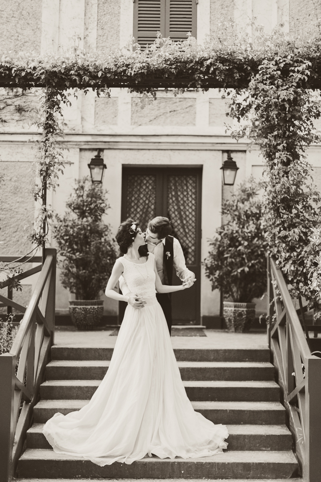 Bride and groom kissing on the stairs 