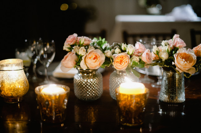 peach flowers and candles in mercury glass