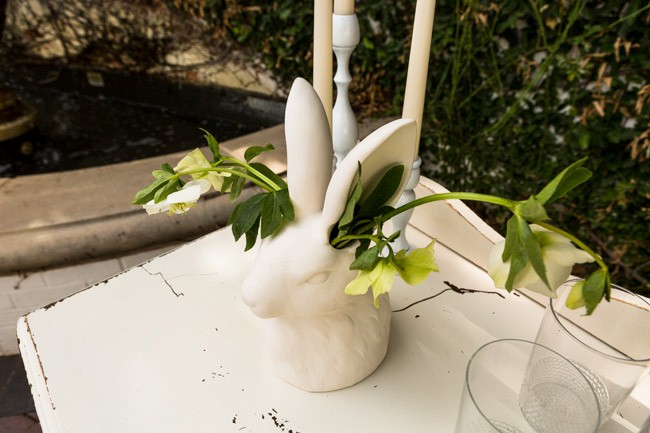 White rabbit figurine vase with roses coming out of ears