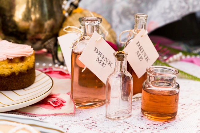 glass flasks with note that says "Drink me"