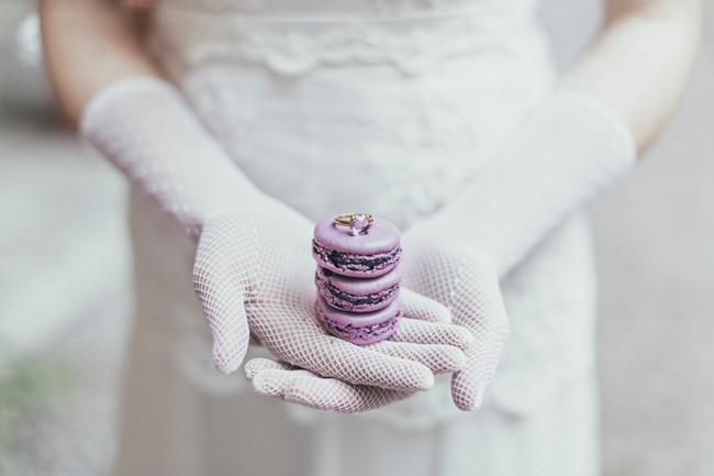 Bride holding macaroon and engagement ring
