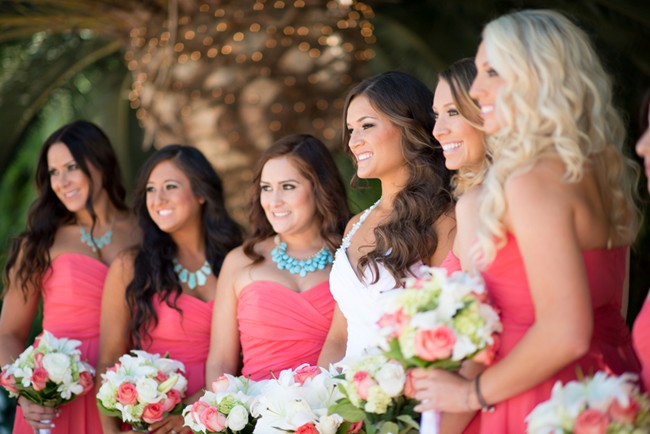 bride with brides maids wearing coral colored dresses 