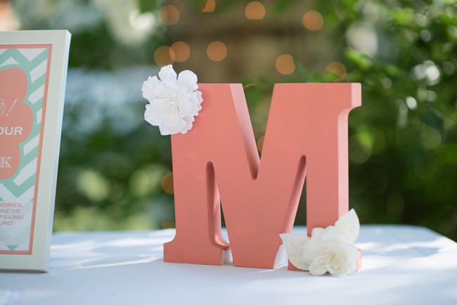 pink letter "M" with white flowers