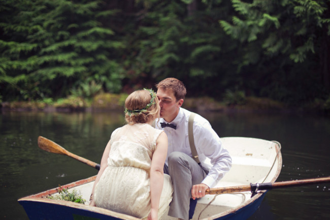 bride and groom kissing in a canoe 