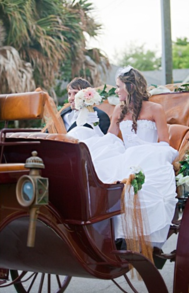 Bride and groom in horse drawn carriage 