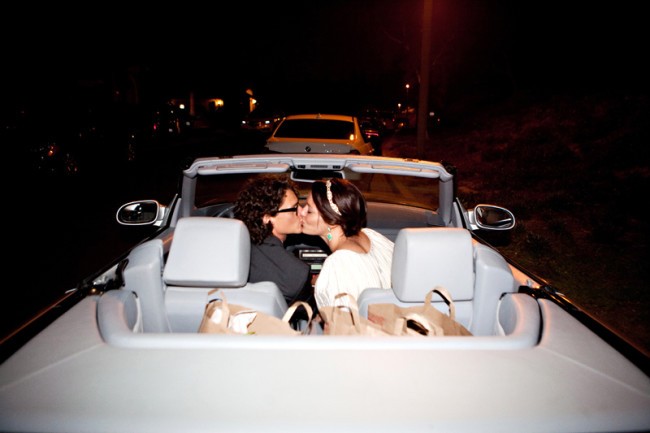 Bride and Groom Kissing in front of convertible in Depart Your Wedding in Style