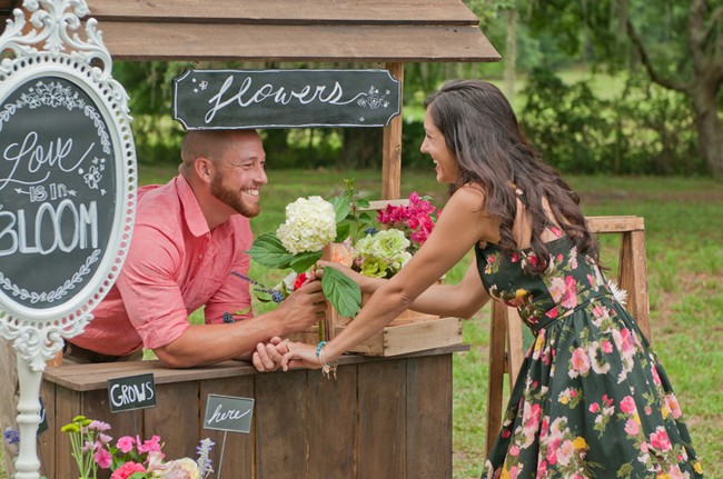 Engaged-couple-at-flower-standg