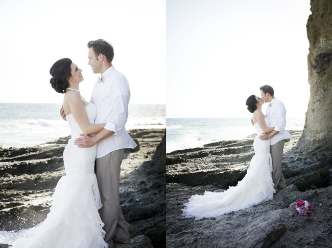 couple stand on rock on victoria beach in laguna beach