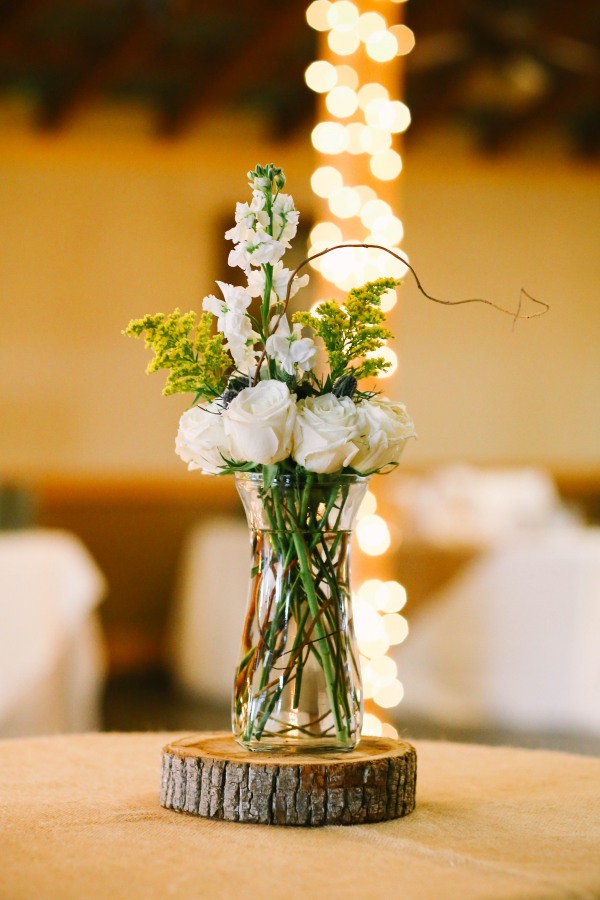 21 white and green wedding reception center pieces on piece of wood at Lindsey Plantation in Greer SC wedding