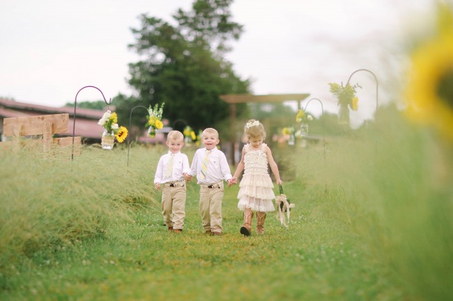 40 Flower girl and rin bearers walking up outdoor wedding aisle at Lindsey Plantation in Greer SC wedding