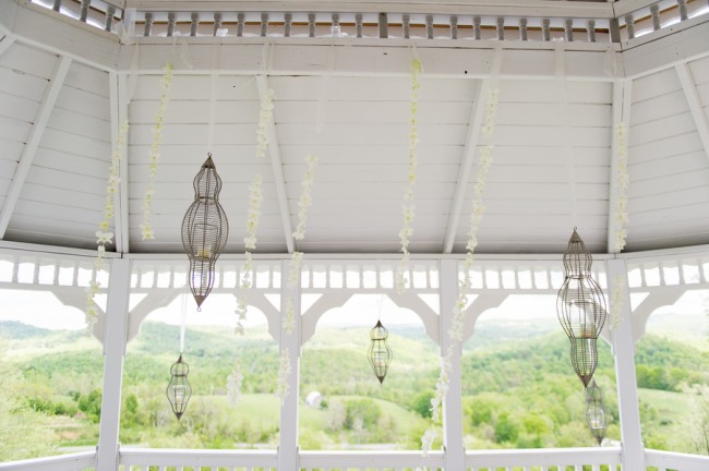 Unique hanging birdcages inside white gazebo