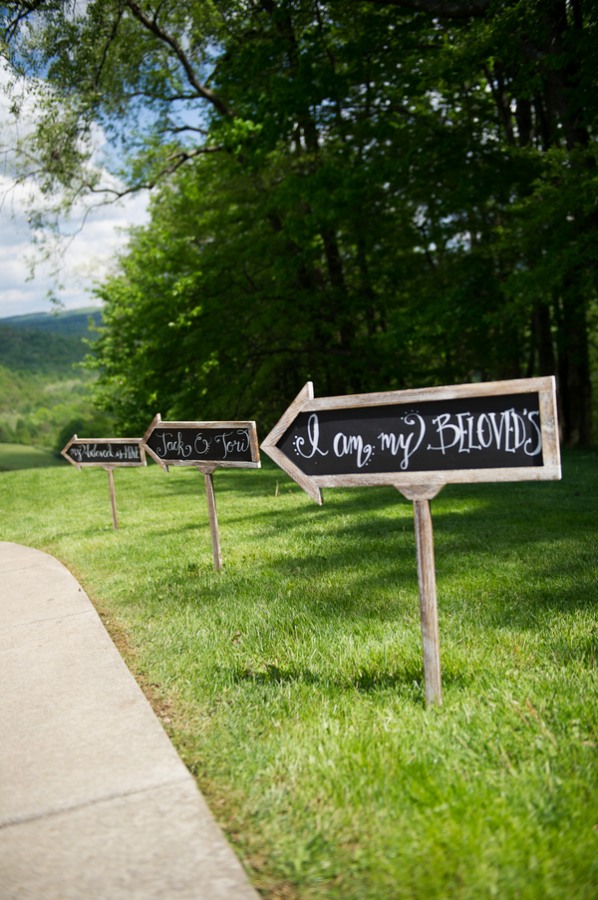 chalkboard arrow sign stakes in grass