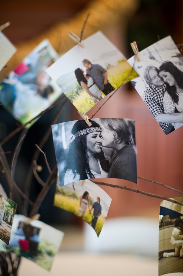bride and groom photos clipped onto tree branches