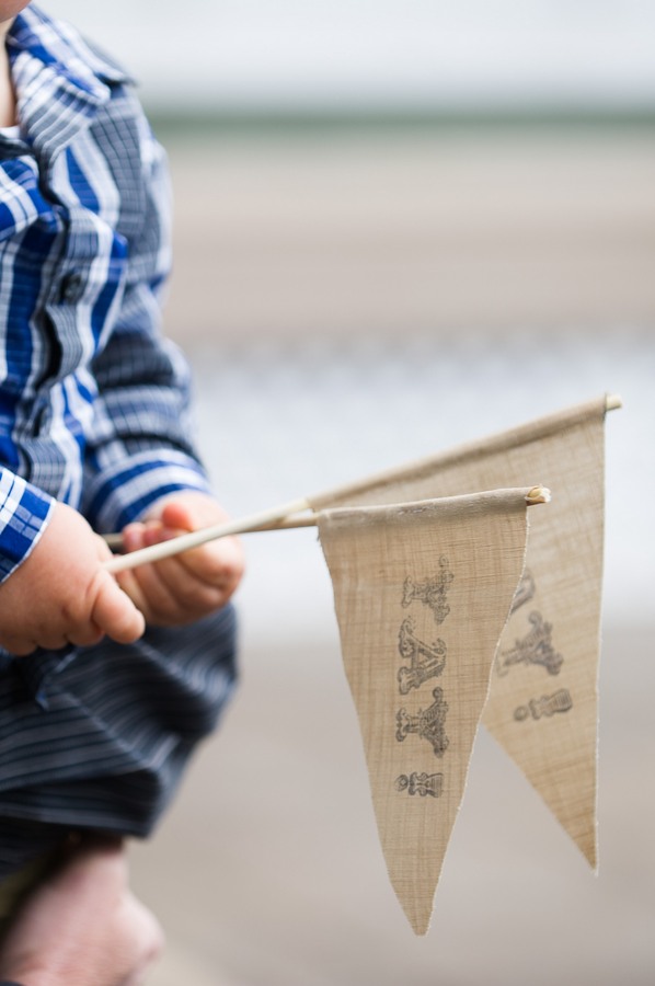 holding two burlap flags with "yay" printed on them