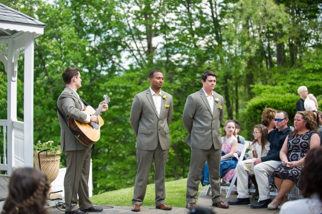 Groomsmen with guitarist at front during wedding ceremony