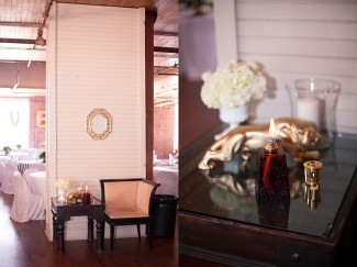 14 lounge area for wedding guests at reception with candle and gold frame and gold lion and white hydrageas
