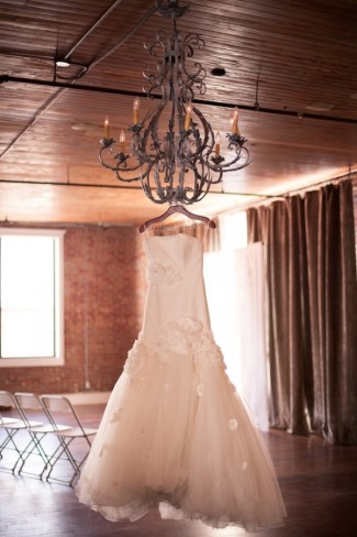 Wedding dress hanging from Chandelier at Aubrey Hall