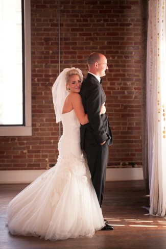5 bride hugging groom from behind during first look