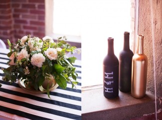6 Gold and black bottle, black and white striped table cloth and flower arrangement