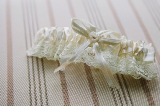 White lace garter with bow and small pearl hearts 