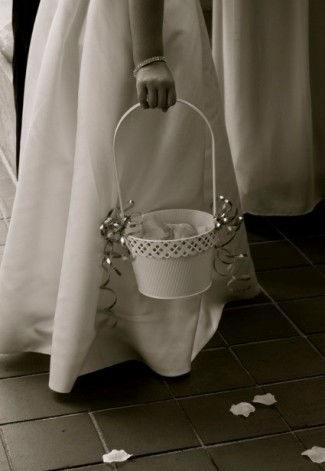 black and white photo of flower girl holding flower petal basket