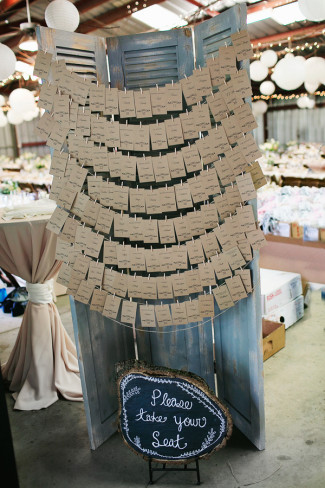 rustic escort cards hanging from shutters for wedding reception