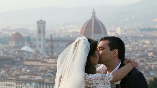 Bride and groom kissing with florence cityscape in the background