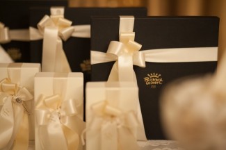 Brown boxes wrapped with cream ribbon for wedding guest gifts