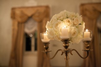 candelabra with white roses in the center