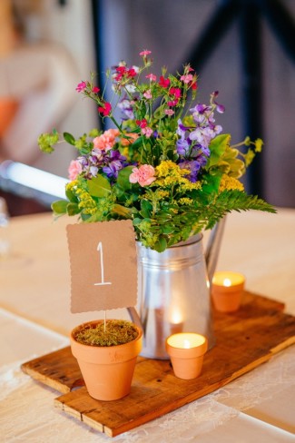 wild flower wedding reception centerpiece using tin watering can and terracotta pots