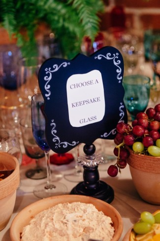 A wedding reception sign asking guest to choose a keepsake glass