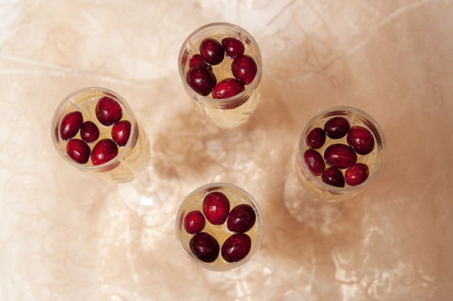 Champagne glasses full of red cranberries 